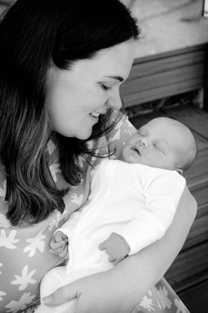 Tender black and white portrait of parent and baby sharing an intimate moment.