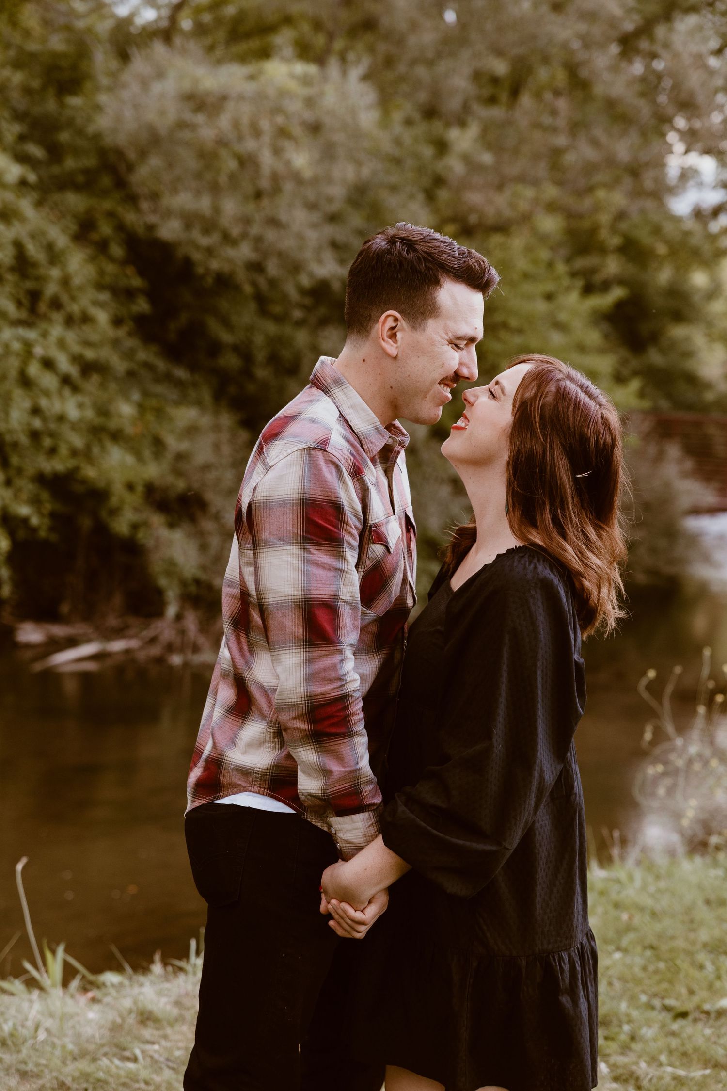 Romantic couple holding hands in nature wearing coordinated outfits.