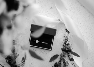 Black and white photo of wedding and engagement rings by Anguelo Photography