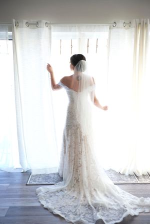 Portrait of a bride showing off her wedding dress by Anguelo Photography
