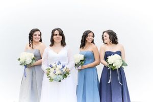Photo of bridesmaids dressed in blue smiling by Anguelo Photography