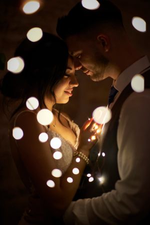 Portrait of bride and groom with fairy lights by Anguelo Photography