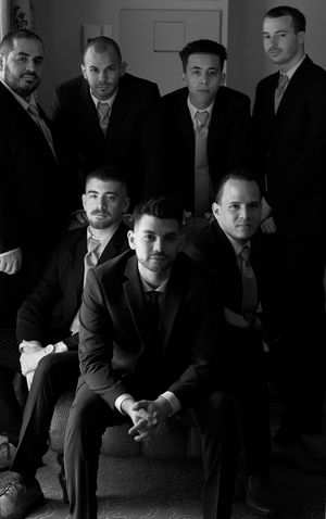 Black and white photo of groomsmen before the wedding by Anguelo Photography