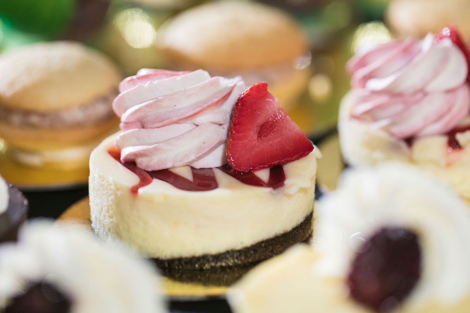 Close-up of delicate dessert bites garnished with fresh berries and cream.