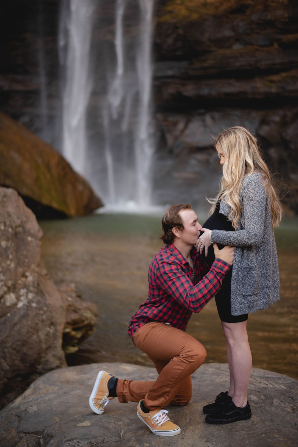 Maternity portrait session of mother and father at a waterfall