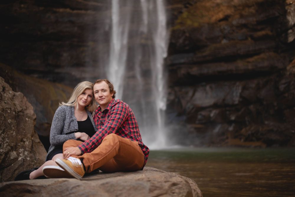 Maternity portrait session of mother and father at a waterfall