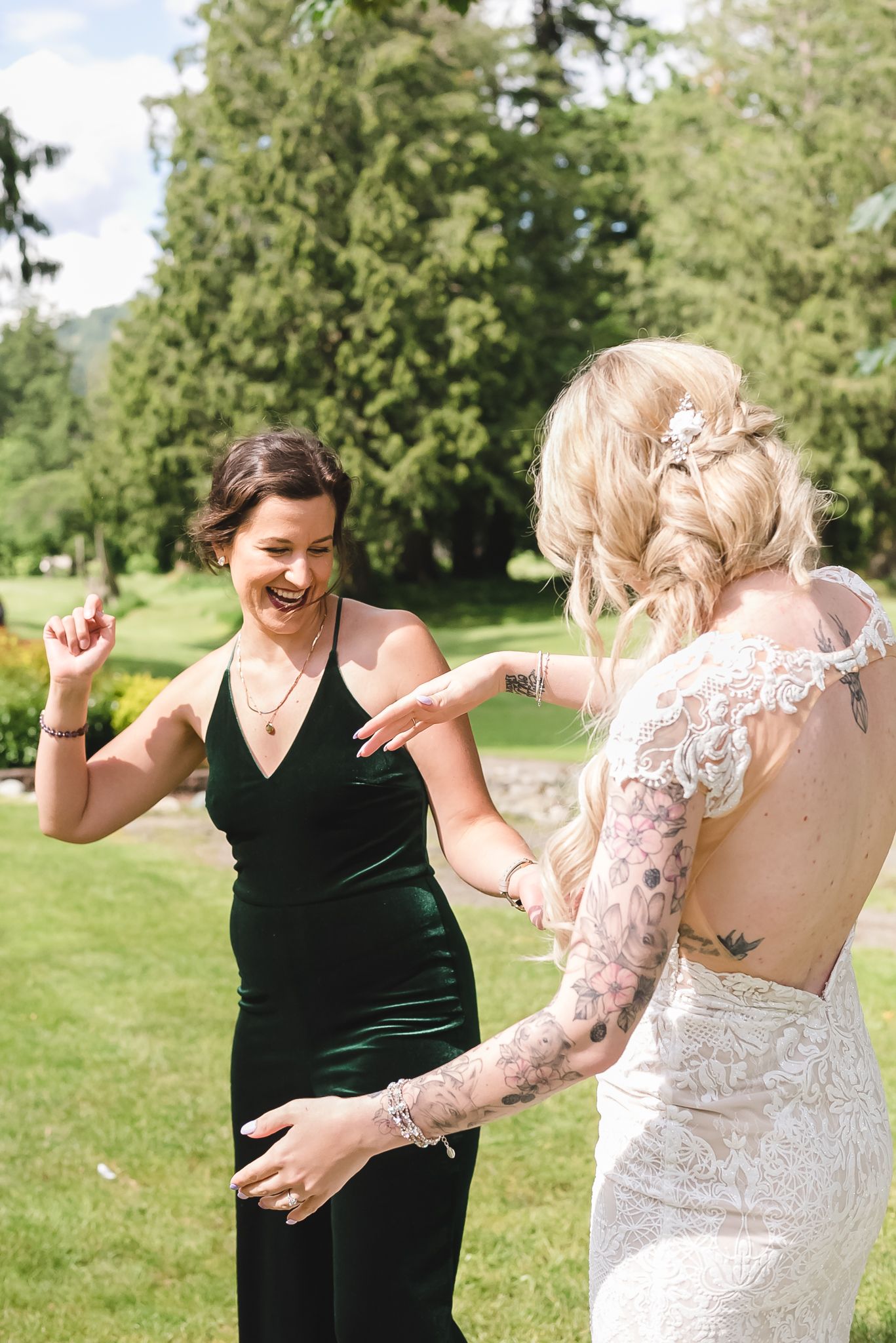 Bride and friend dance to celebrate on the golf course. Photo in Hope by Fraser Valley wedding photographer, Kari Mills.