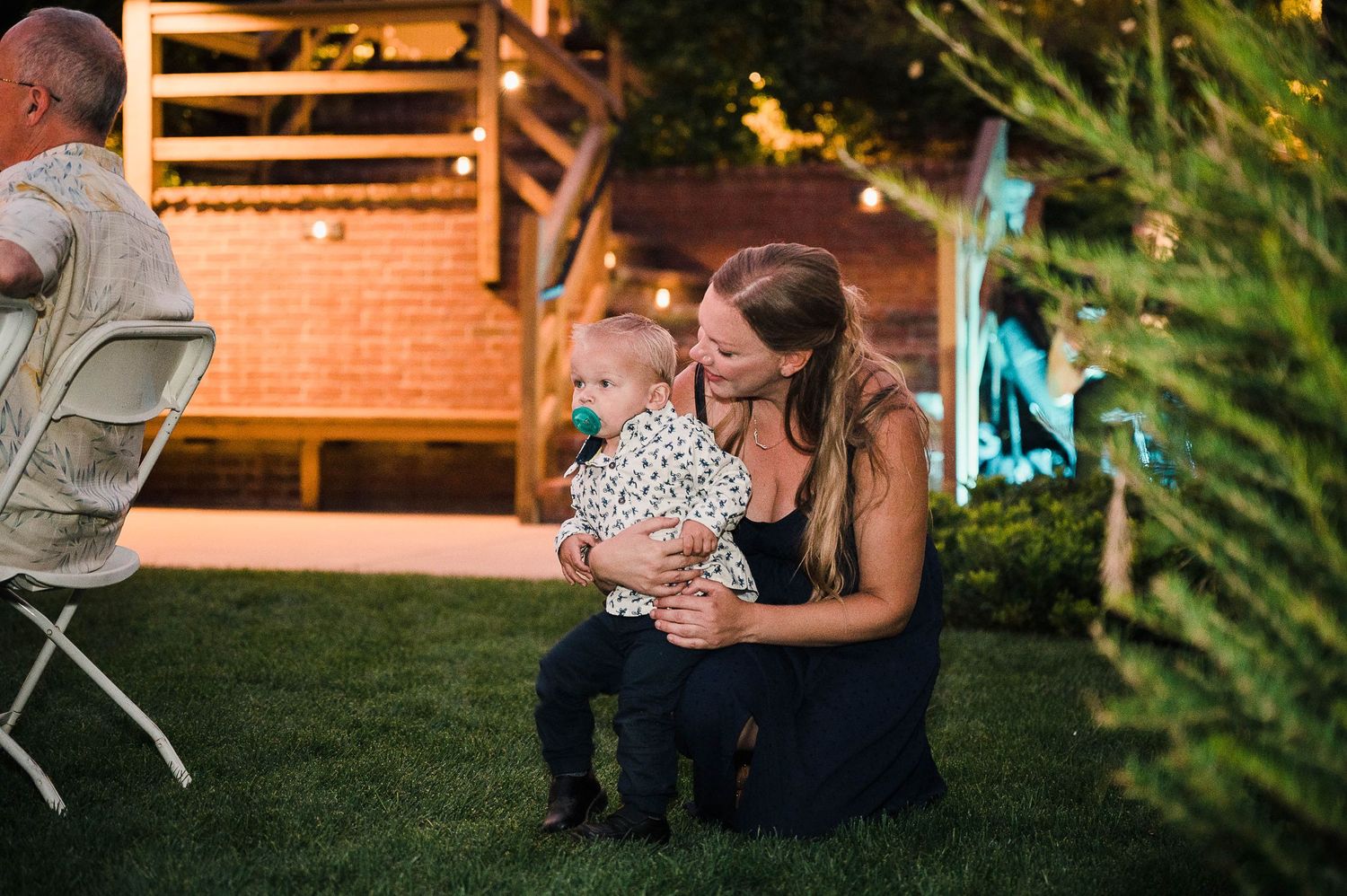Evening outdoor reception with warm lighting and garden decor.