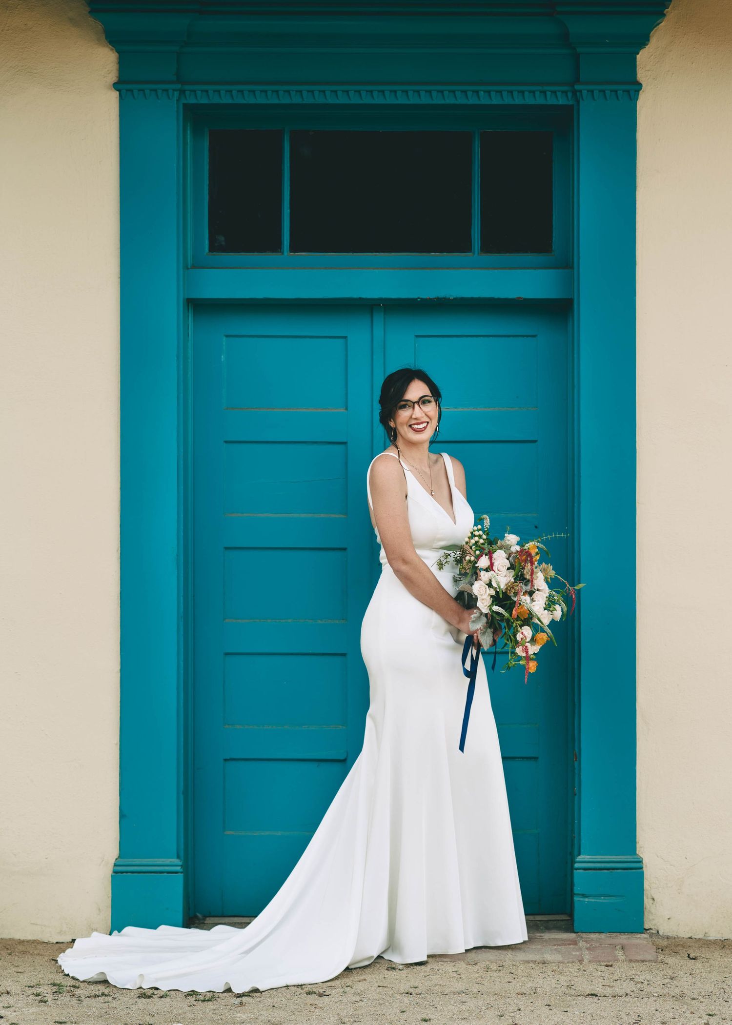 Bride in front of blue door at Cooper Molera in Monterey