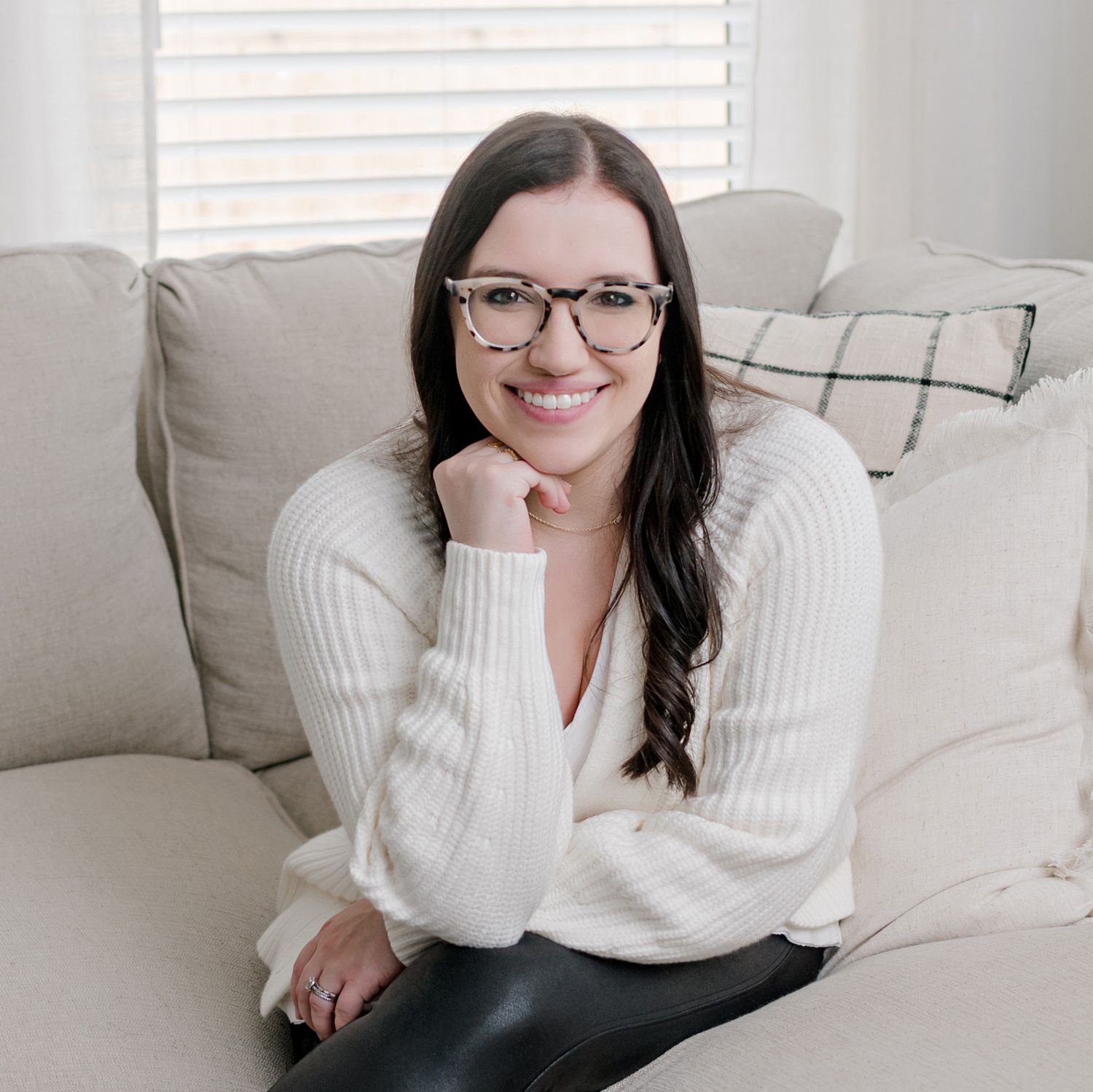 photographer smiling at the camera with her hand resting under her chin