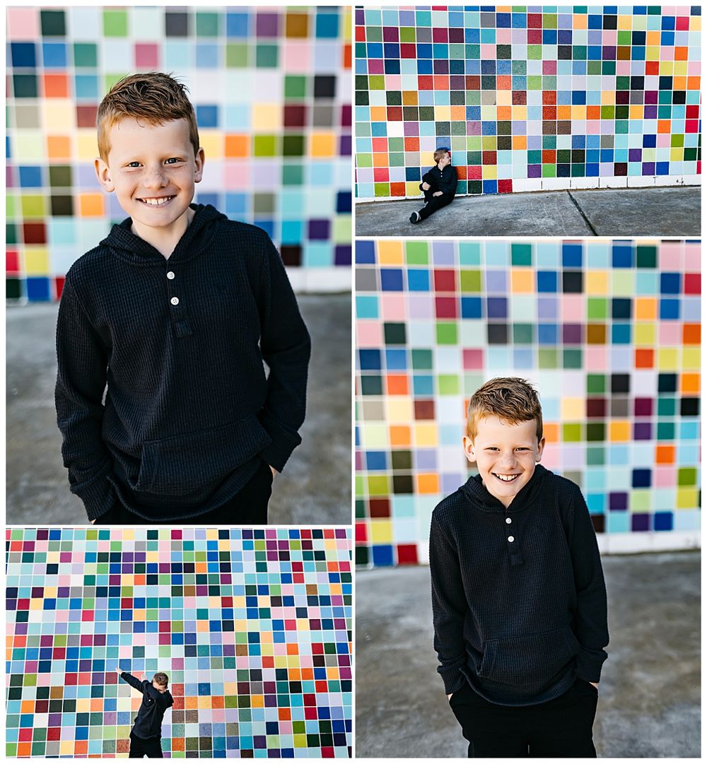 child has hands in pockets as he smiles by San Diego photographer