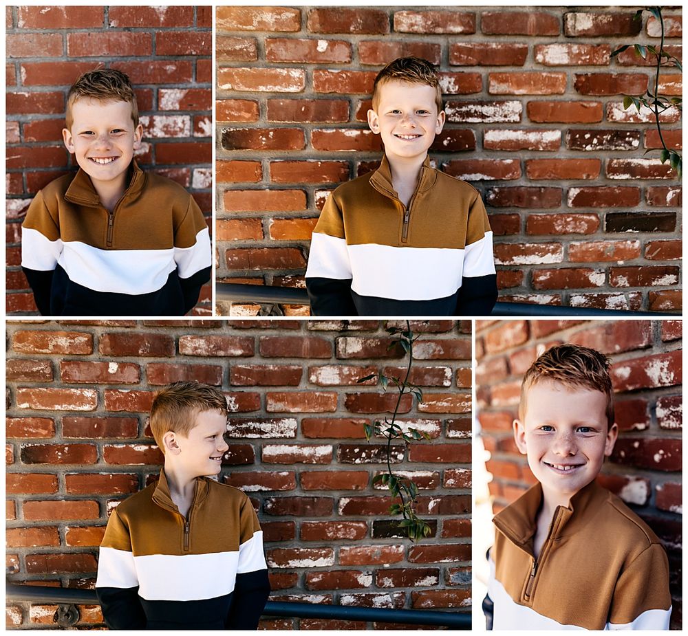 boy stands in front of brick wall by Danielle Miranda Photography