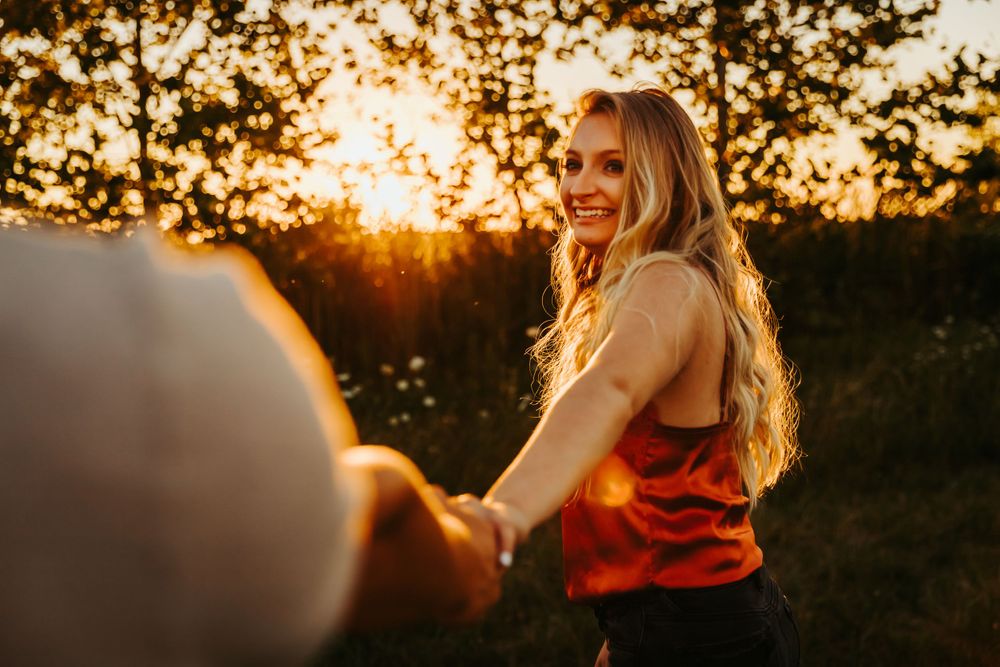 Couple holding hands at sunset with warm golden light natural outdoor setting. terre haute family wedding photographer parke county