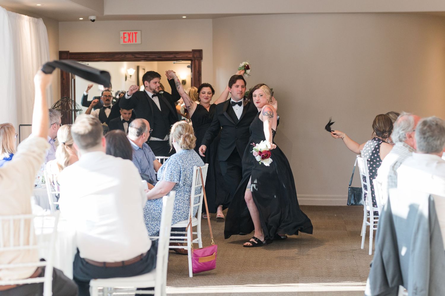 Wedding reception candid moment with guests gathered for celebration in dining room.