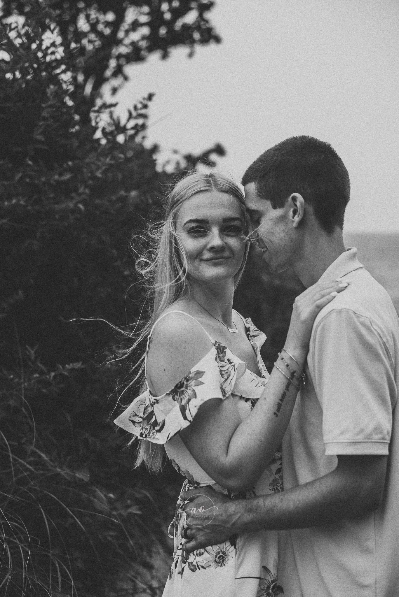 Couple being photographed during couples session at local beach in South Eastern CT beach