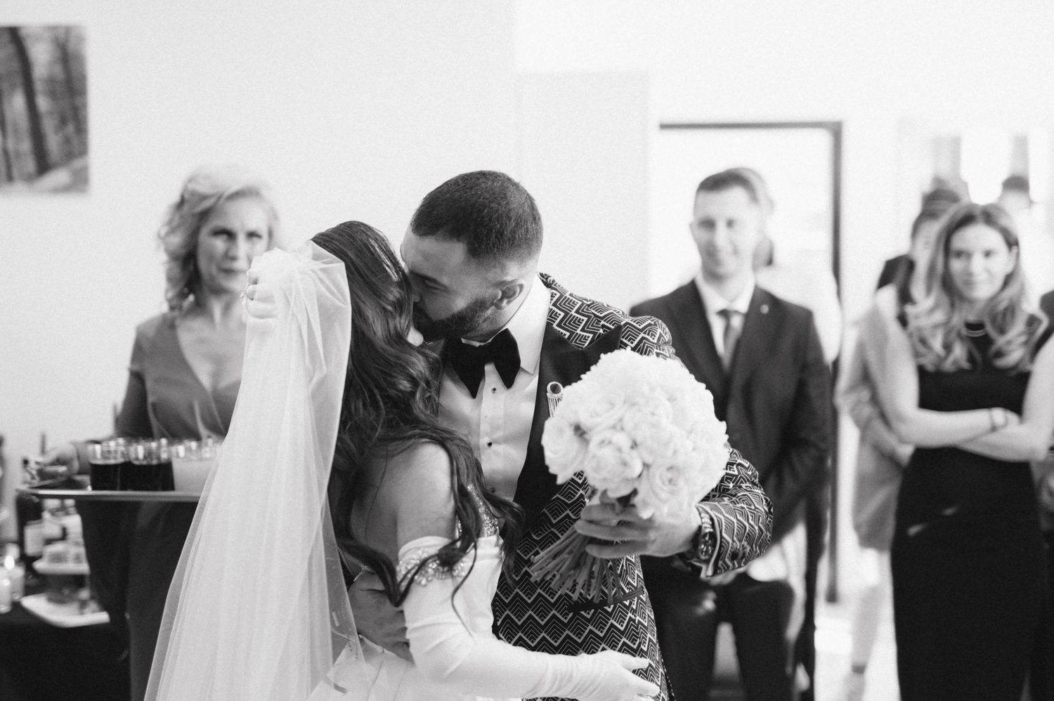 Black and white candid moment from intimate wedding ceremony.