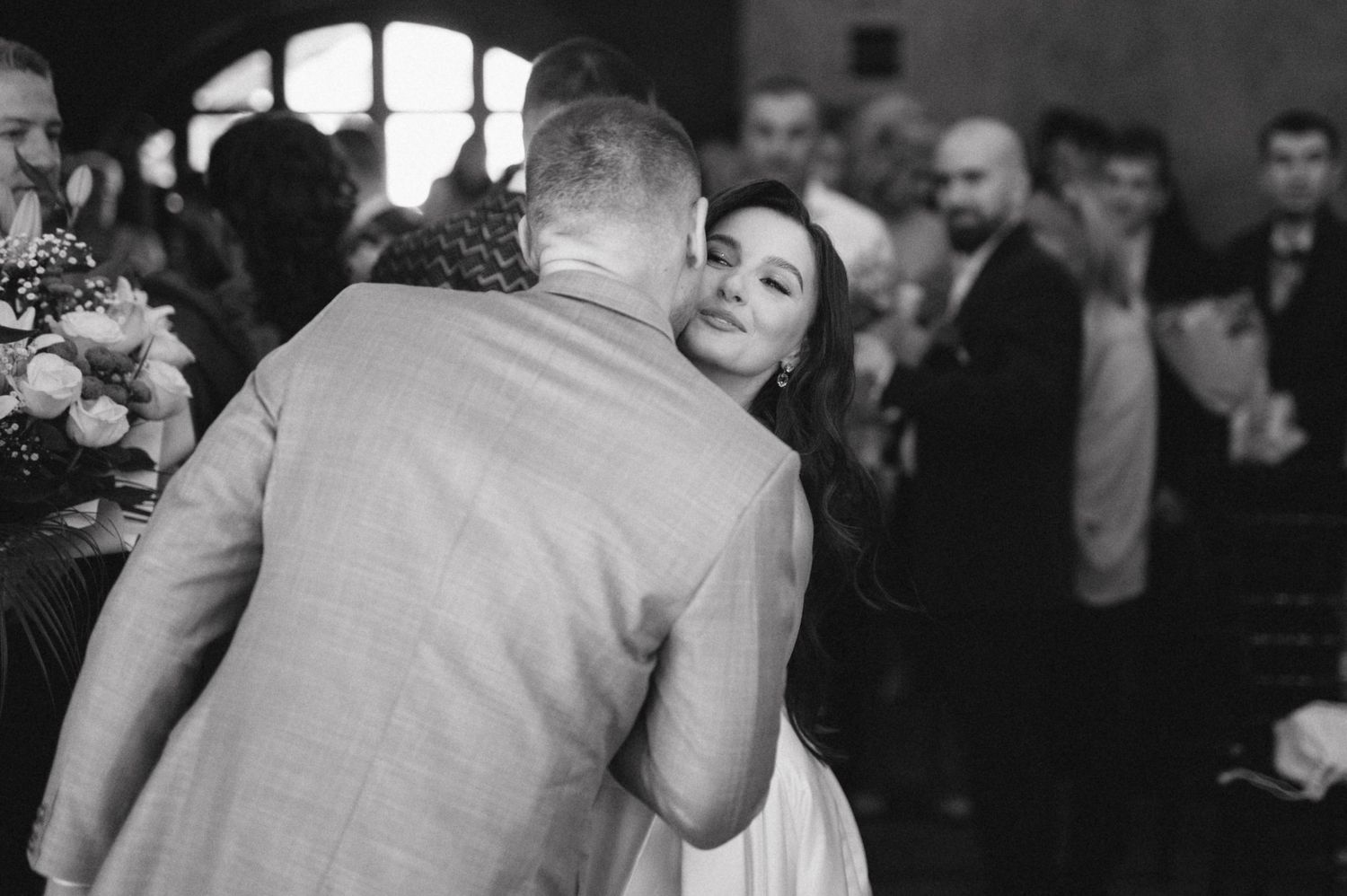 Intimate black and white moment captured during wedding reception dance.