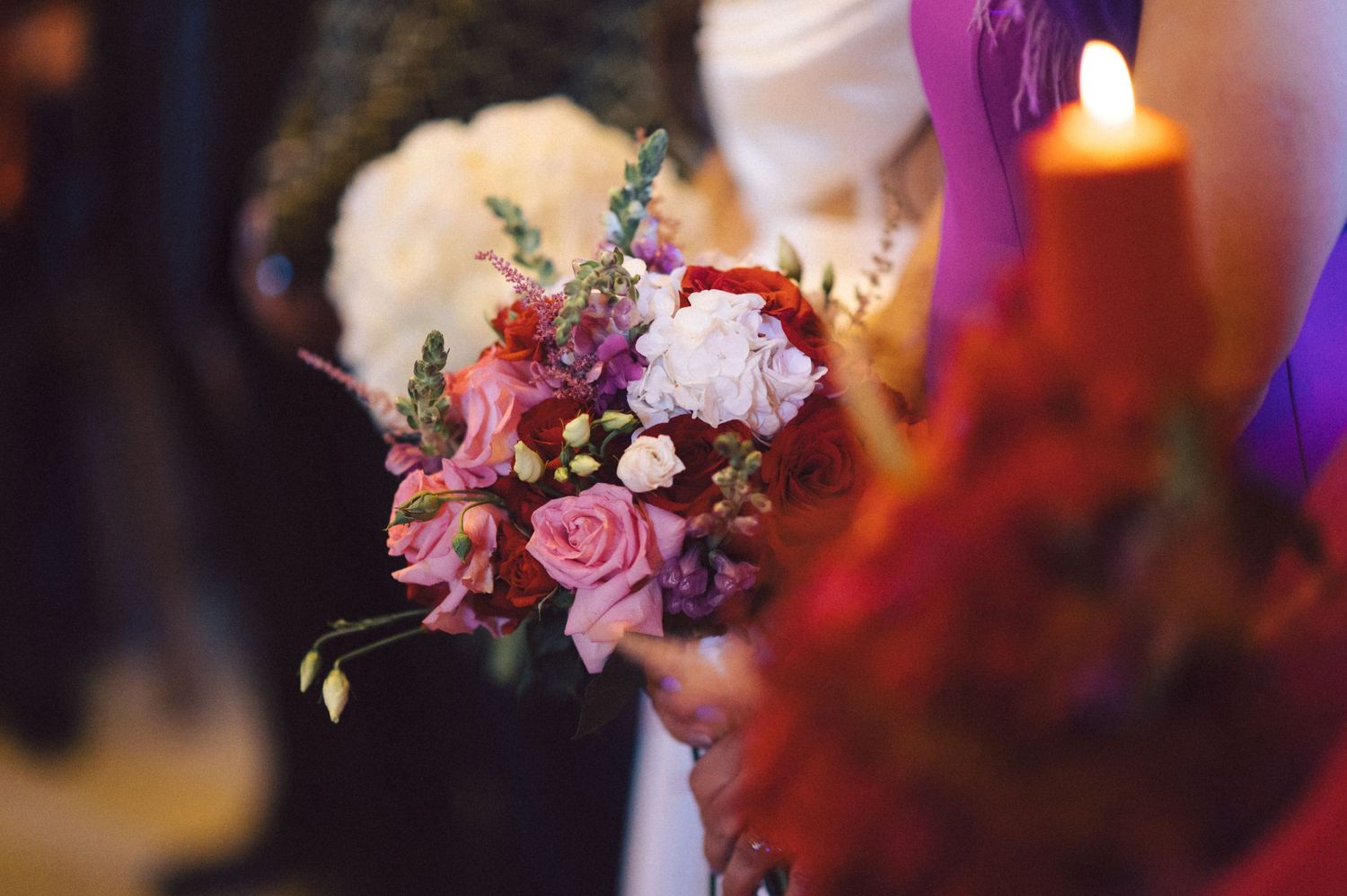 Beautiful wedding floral arrangement featuring pink roses and mixed flowers.