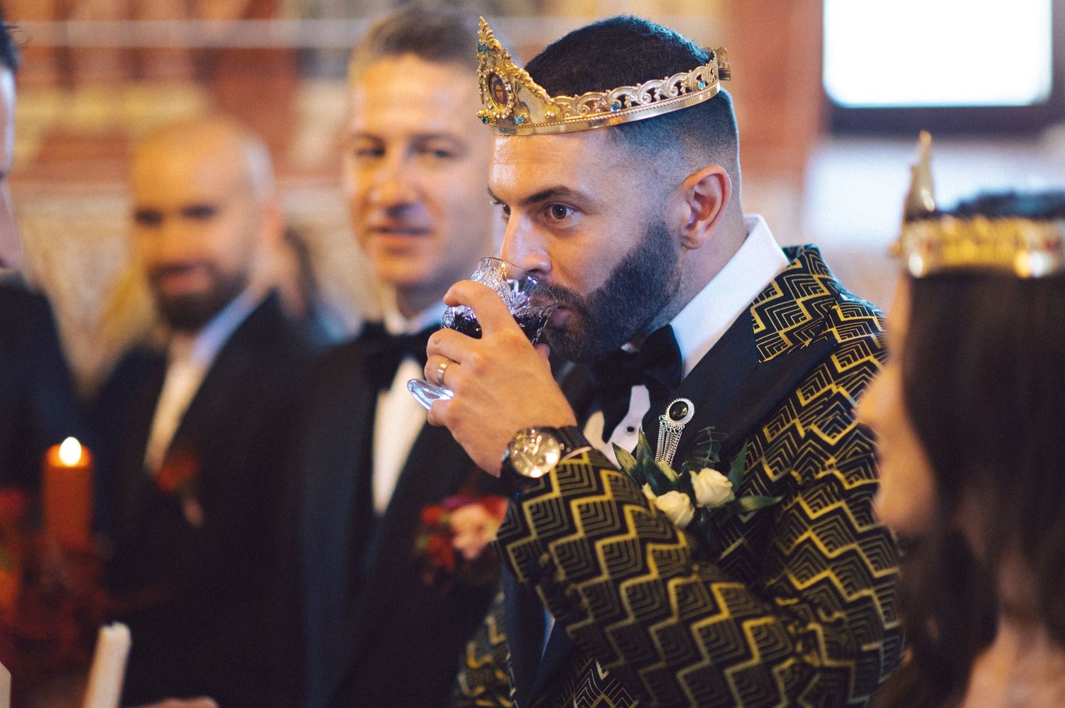 Wedding ceremony in an Orthodox church with decorative gold pattern details.