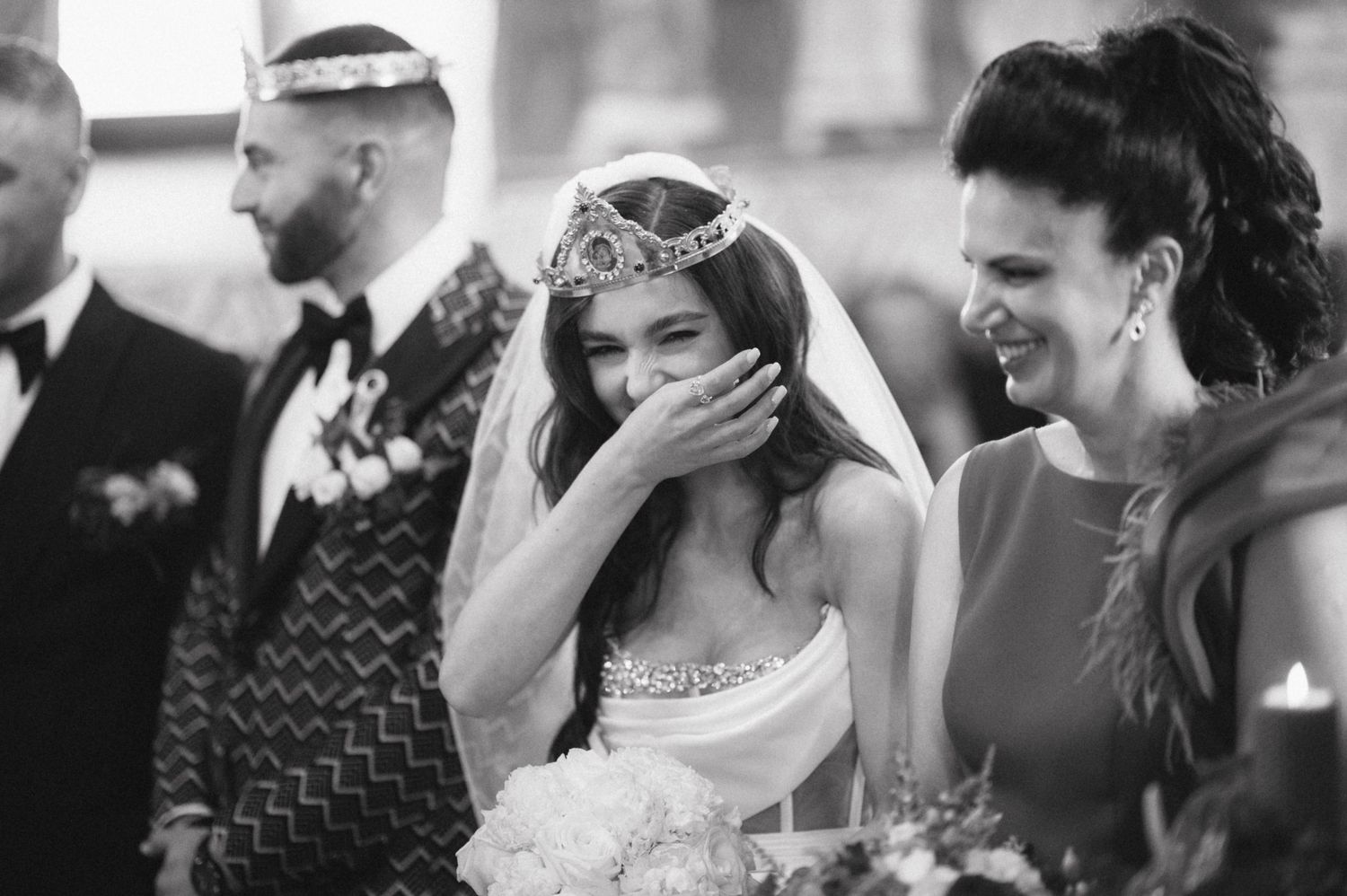 Black and white capture of joyful moments during an Orthodox church wedding ceremony.