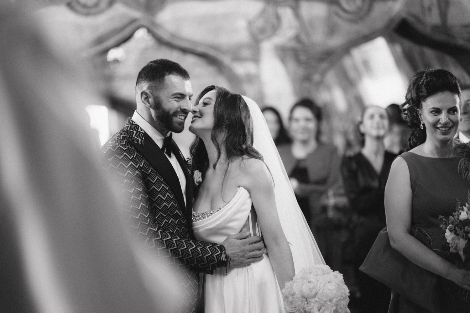A tender moment captured in black and white during a wedding celebration.