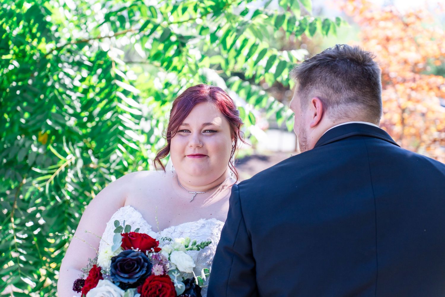 bride looks over groom's shoulder