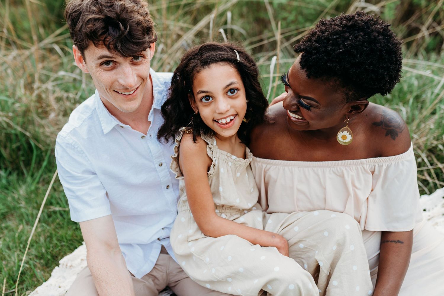 Family sits on the ground at Overlook Park in Lancaster, PA for their family photo session