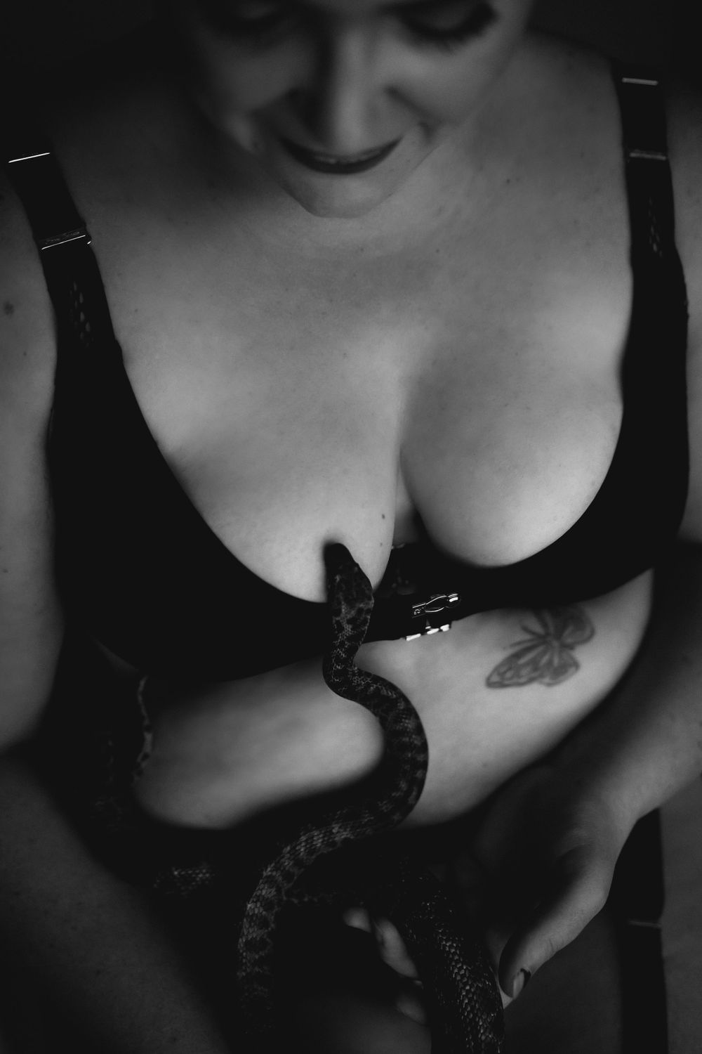Black and white artistic boudoir photography with dramatic lighting and shadows.