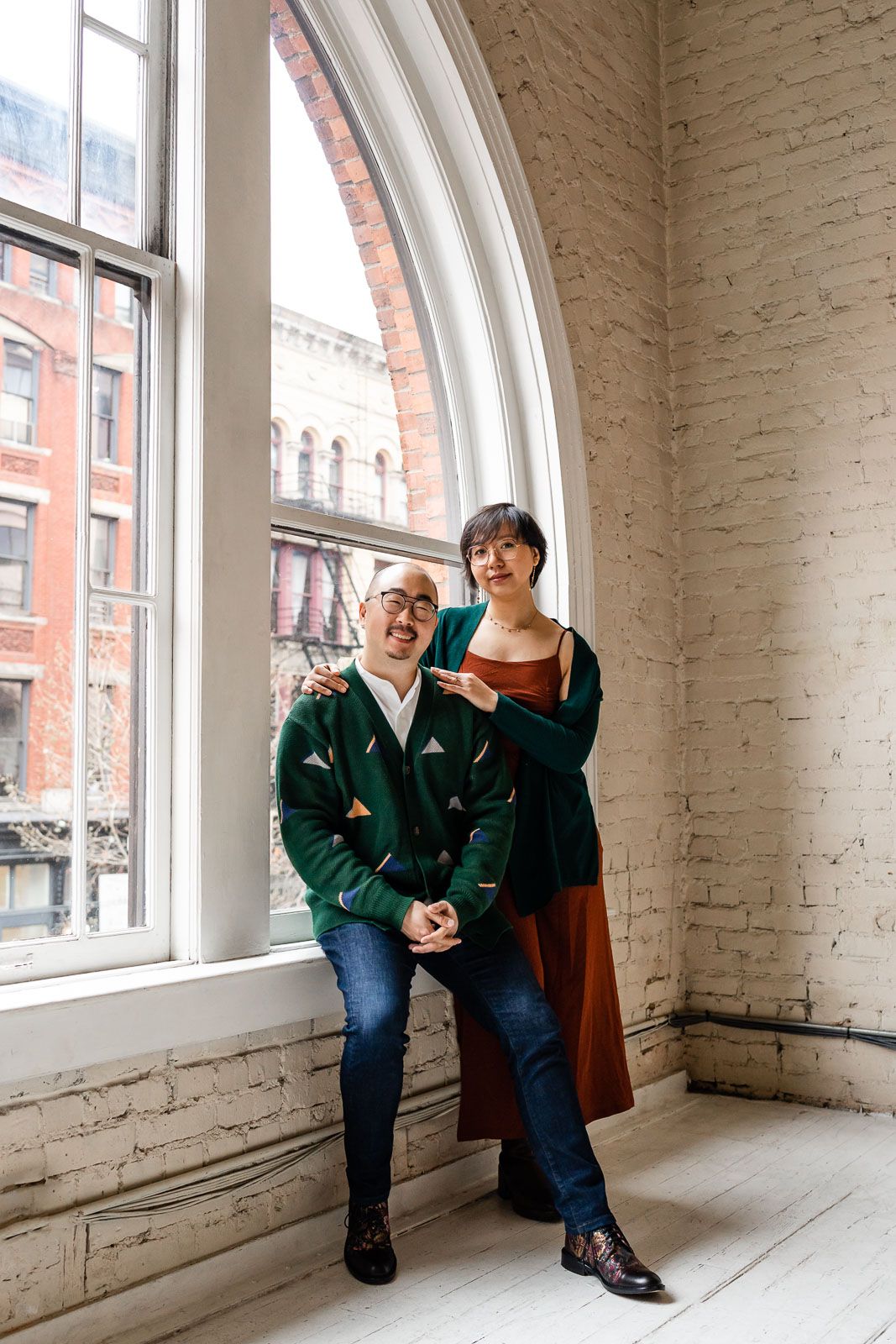 Husband and wife portrait by an arched window