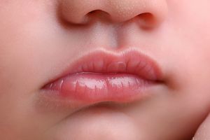 Close-up macro shots of baby lips in pink tones.