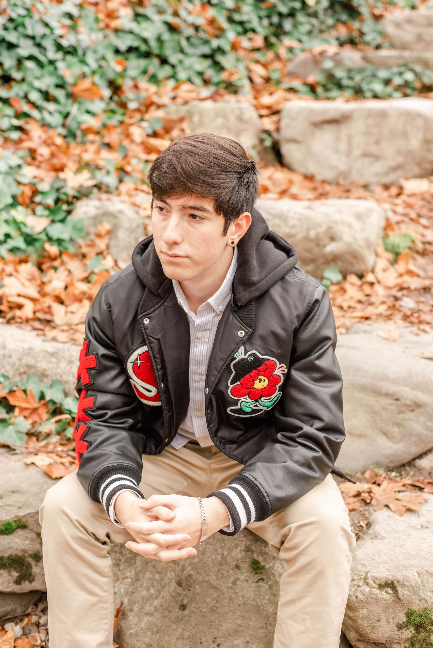 Casual outdoor portraits on stone steps with autumn foliage in background.