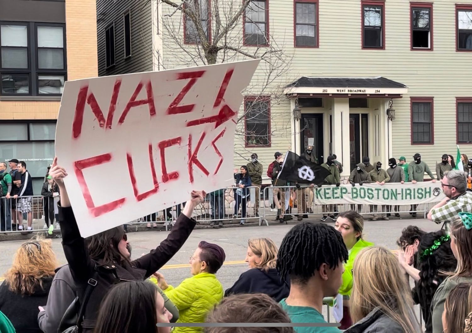 Lauren Pespisa holding sign Nazi Cucks pointed at NSC-131. Photo by Rod Webber