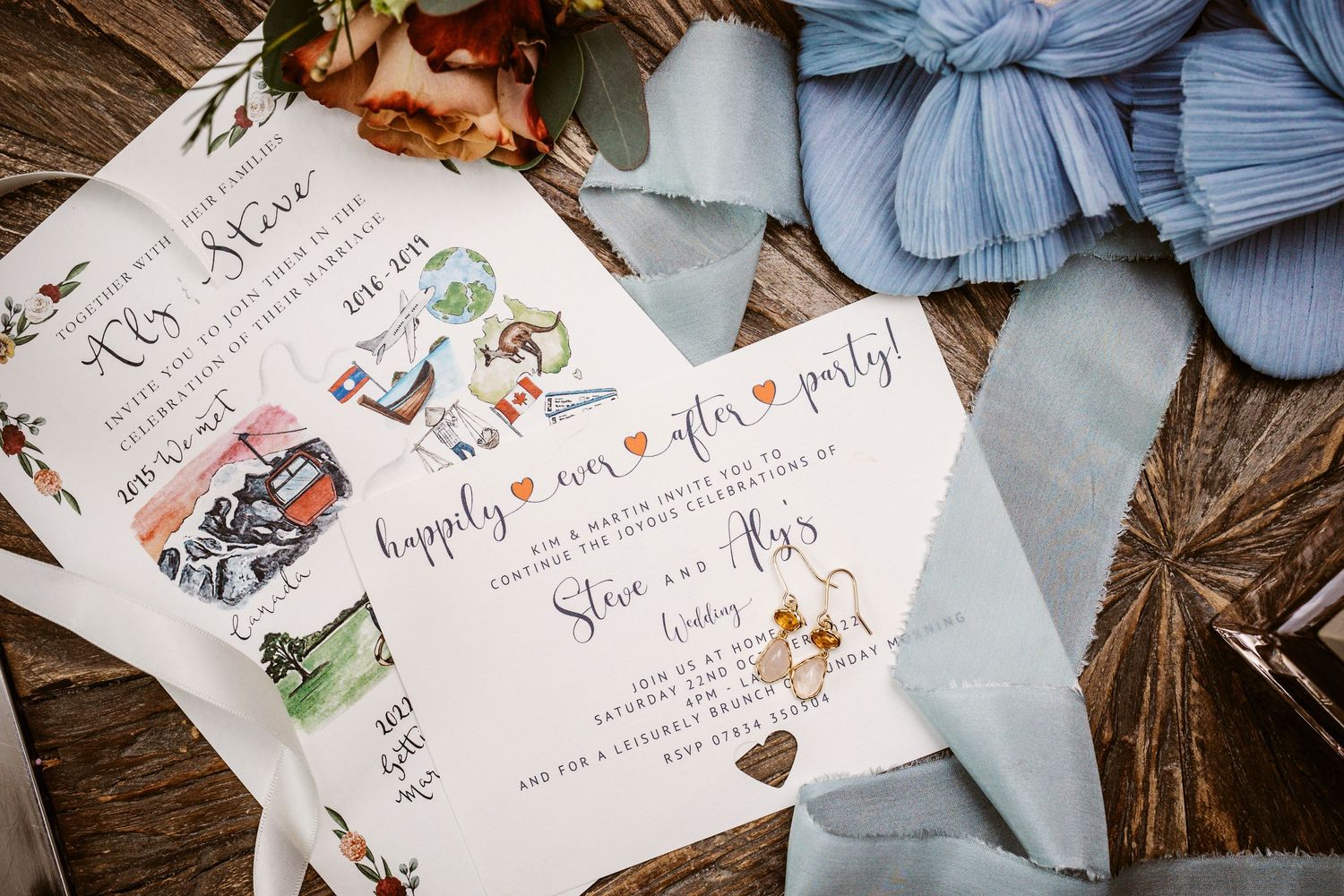 Beautifully designed wedding invitations with watercolor illustrations and blue accents.
