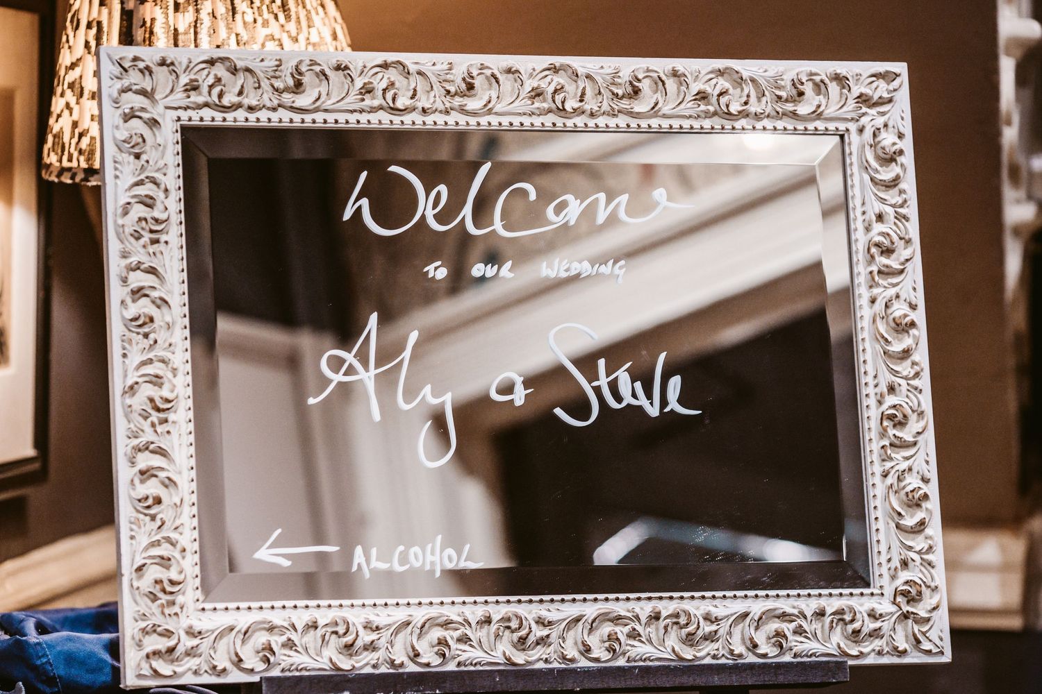 An ornate white frame displays 'Welcome' text written on a reflective surface.