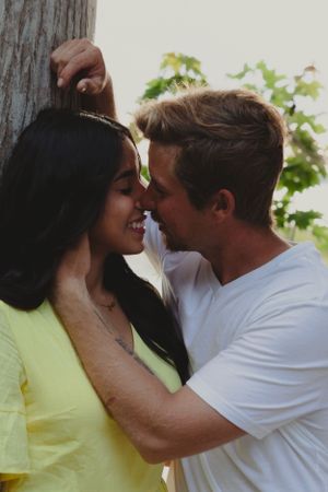 A romantic couple in yellow and white outfits share intimate moments in a series of close-up photos.