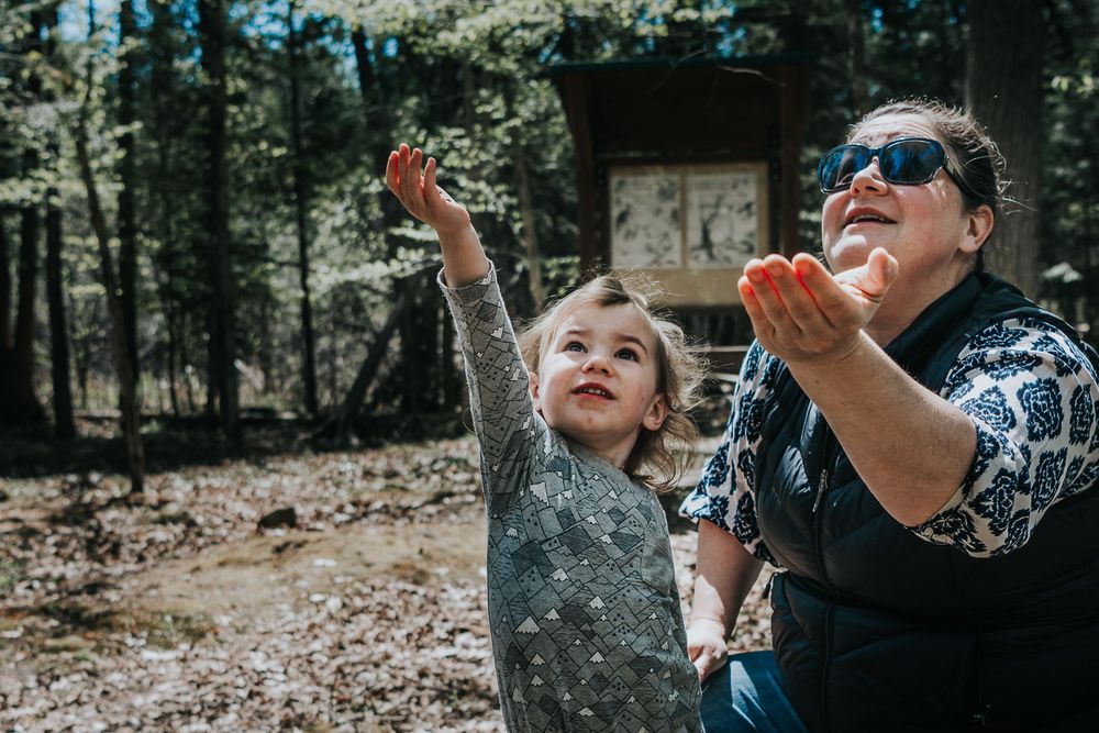 With hands outstretched, a mother and her daughter feed the chickadees at Jack Pine trail in Ottawa.
