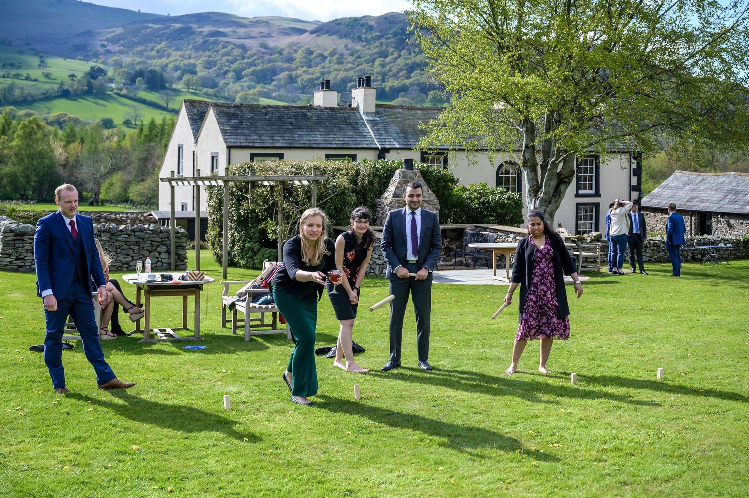 Wedding guests playing garden games at New House Farm in Lake District