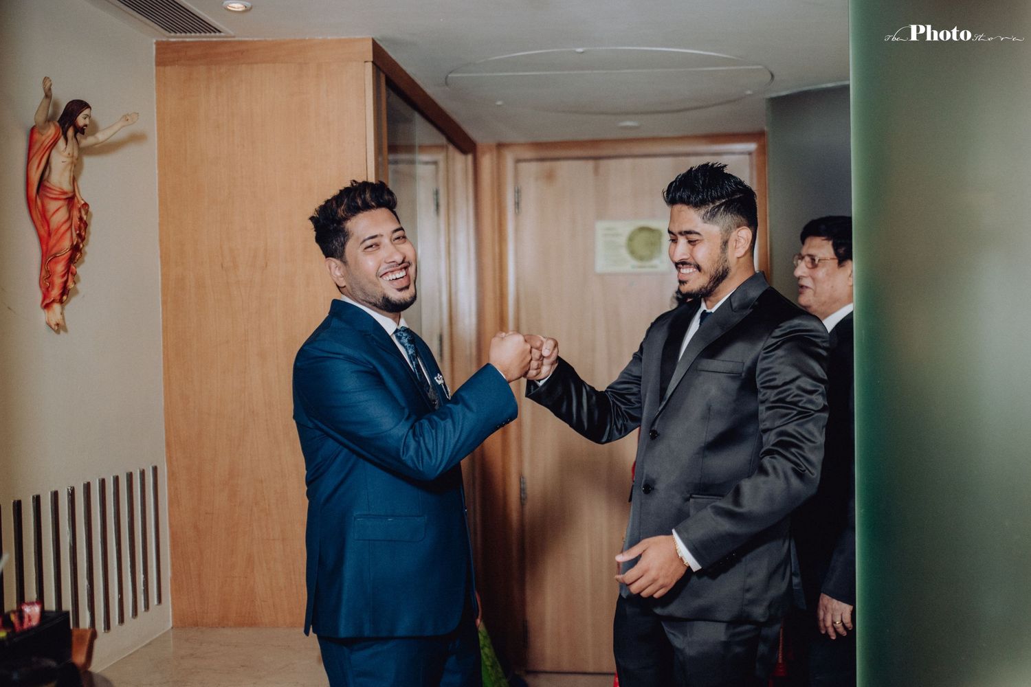 Candid moments between wedding party members in a hallway setting.