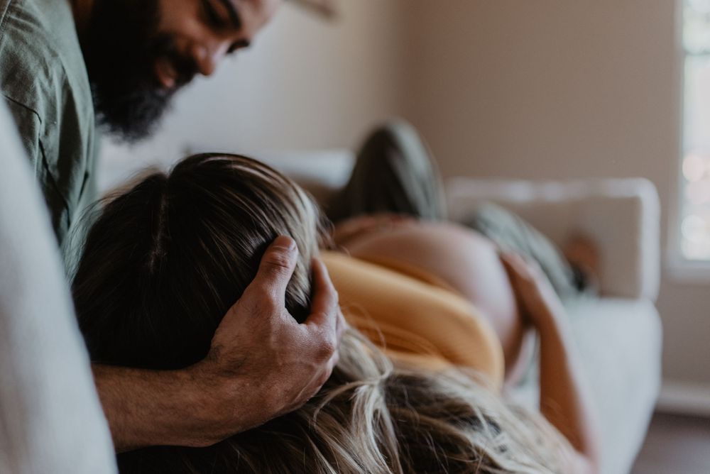 Intimate close-up of couple sharing tender moment during maternity session.