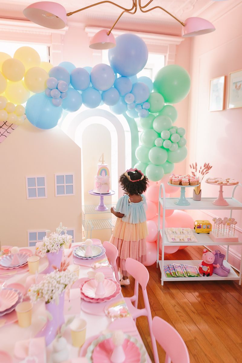 a candid view of a girl looking at her birthday party cake and decor at home in Brooklyn, photo by Paula Ortiz NYC