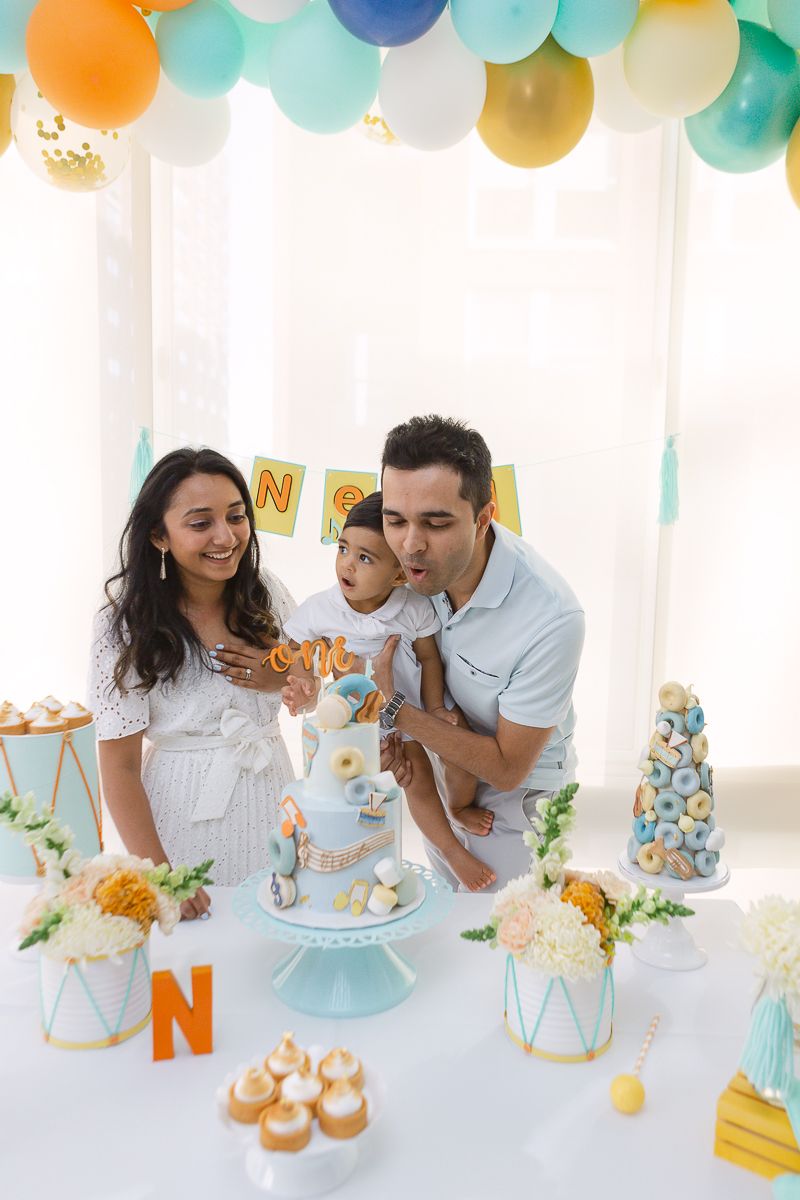 a candid view of a family blowing the candles during the first birthday party of their son in Hoboken, photo by Paula O