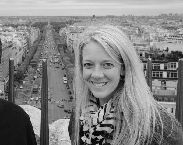 View from above showing a cityscape with long street stretching into distance in black and white.