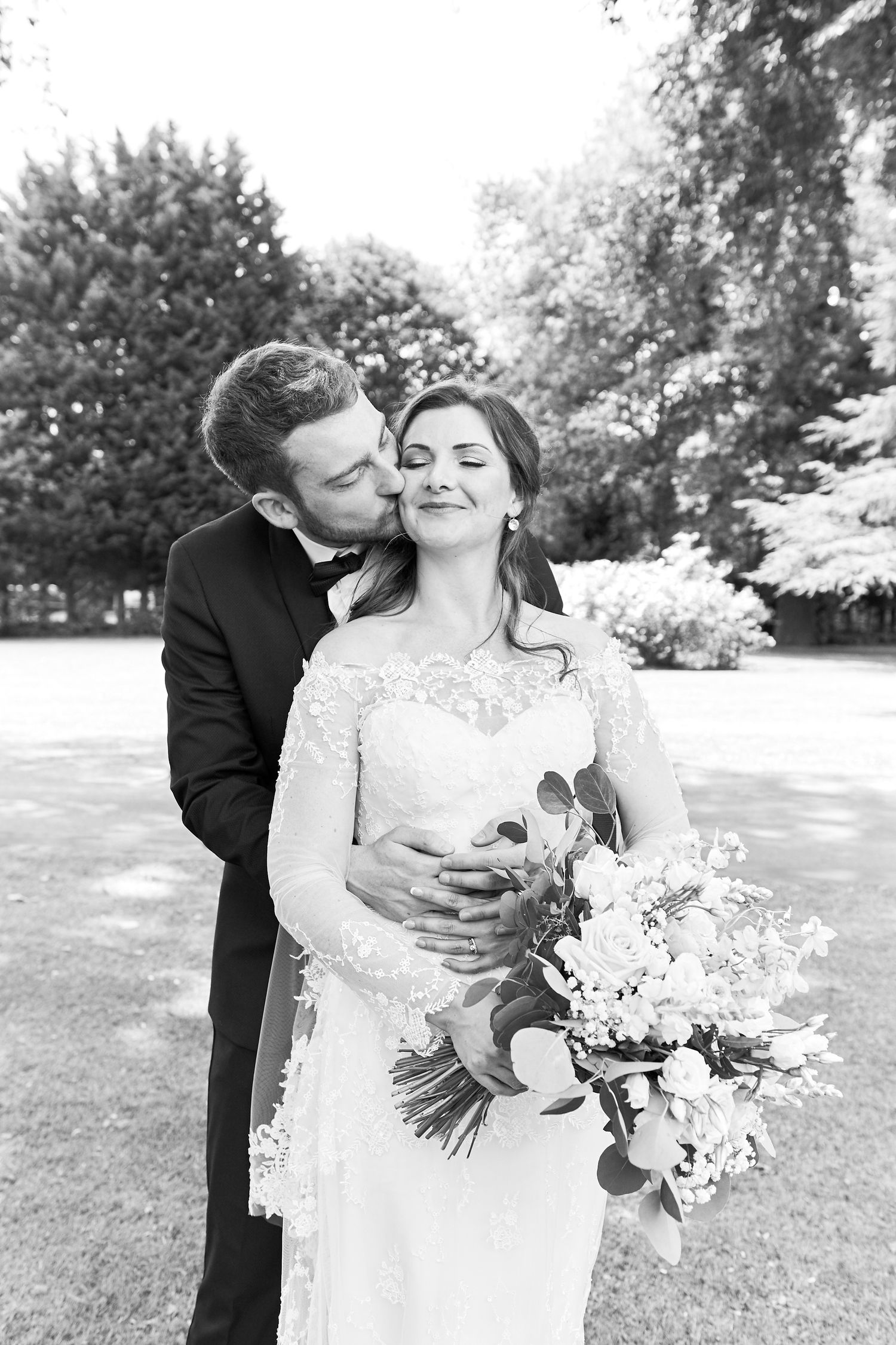 bride & groom portrait in gardens at luxury Orsett Hall wedding by Norwich's best wedding photographer Faye Amare