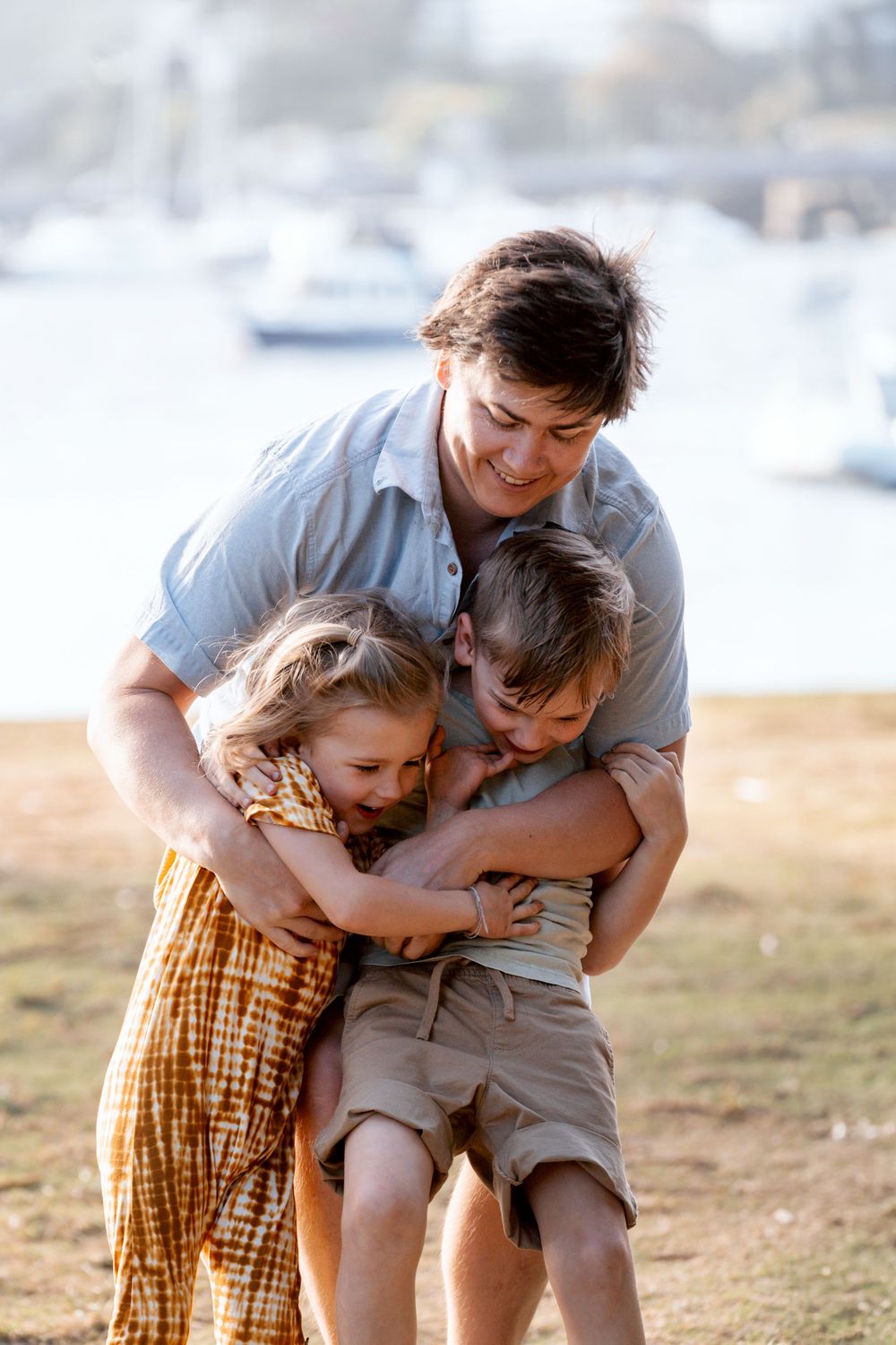 big hug from a father to his sons during a family photoshoot in Clontarf Sydney