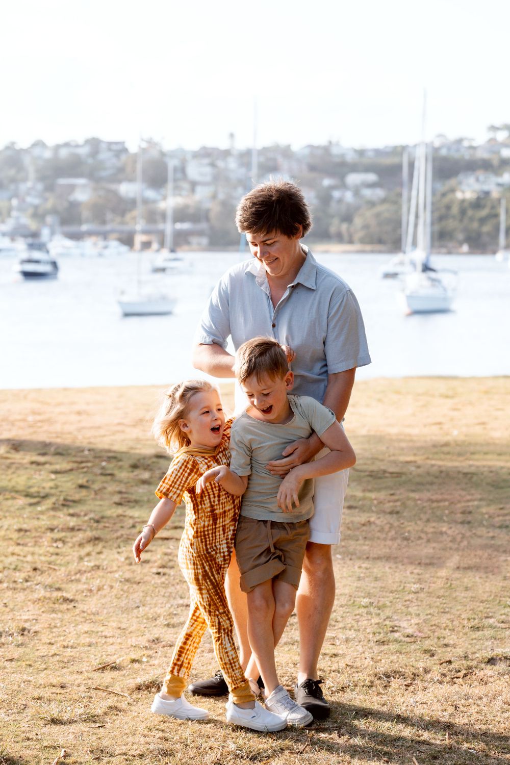 Dad hugs his sons during family photoshoot in Sydney