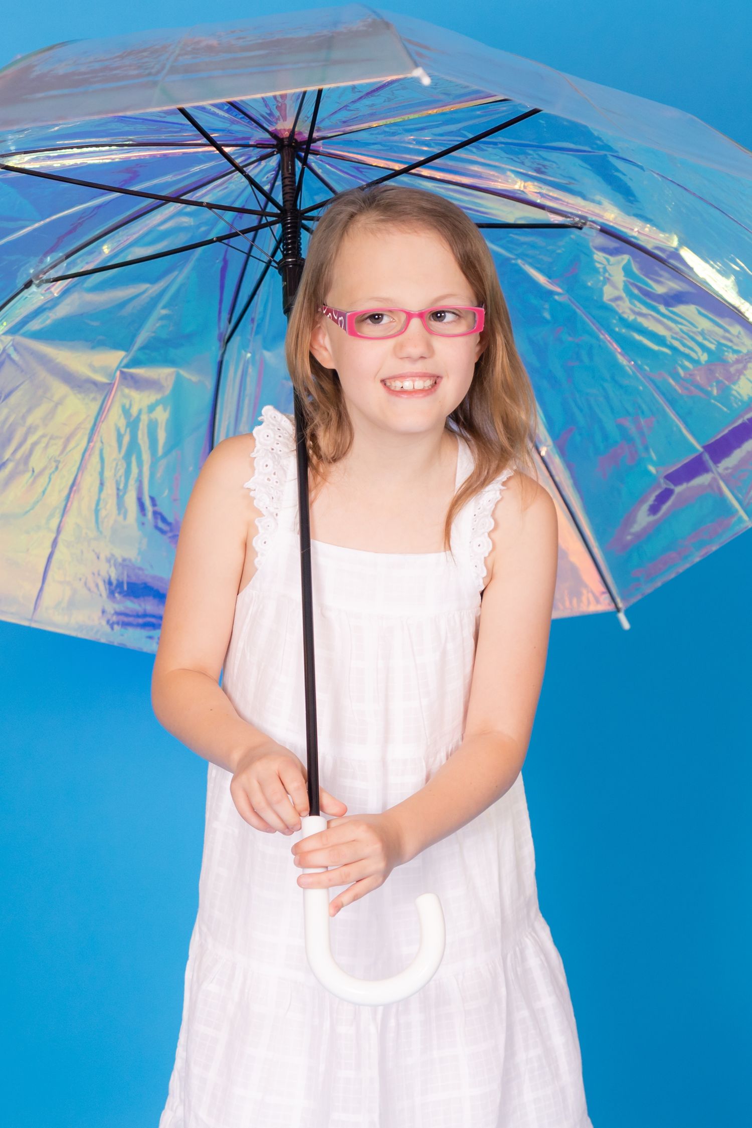 girl holding iridescent umbrella on savage blue jay backdrop in studio in clayton new jersey Gloucester