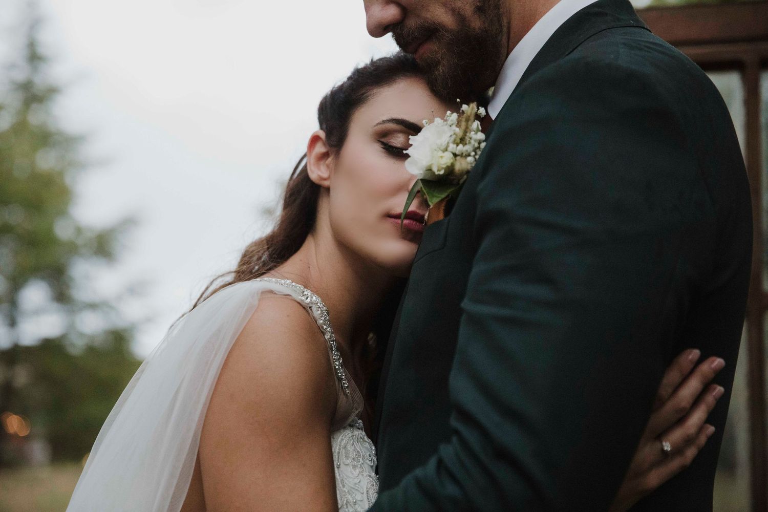 Intimate wedding portrait with delicate floral details.