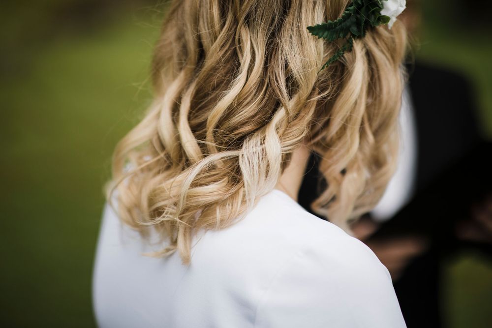 Dramatic waterfall view through blurred wedding ceremony foreground.