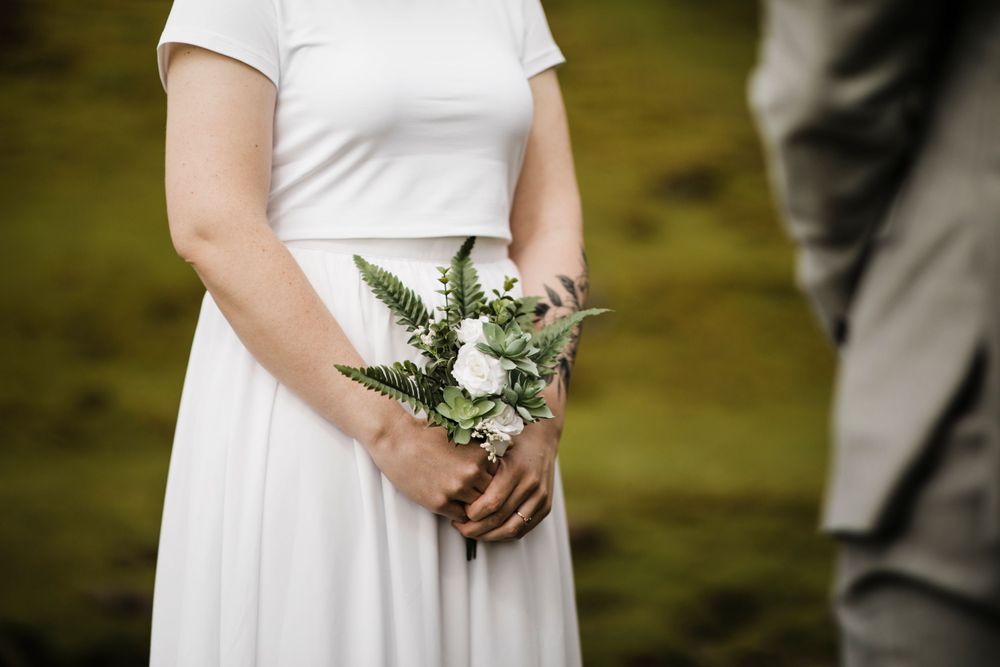 Intimate wedding ceremony taking place against dramatic Icelandic landscape.