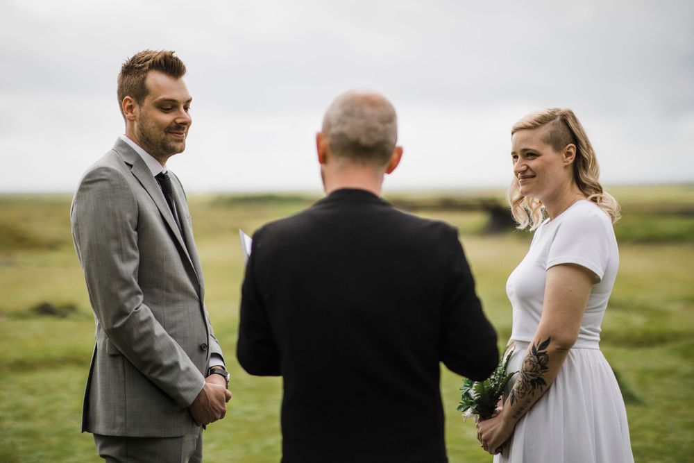 Outdoor wedding ceremony in a dramatic rocky canyon with moss-covered cliffs.